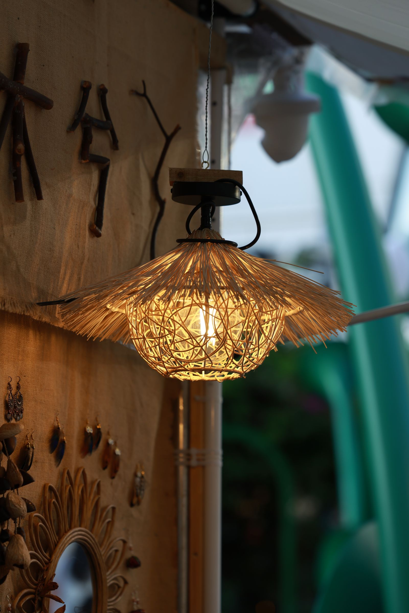 A woven wicker pendant lamp glowing warmly